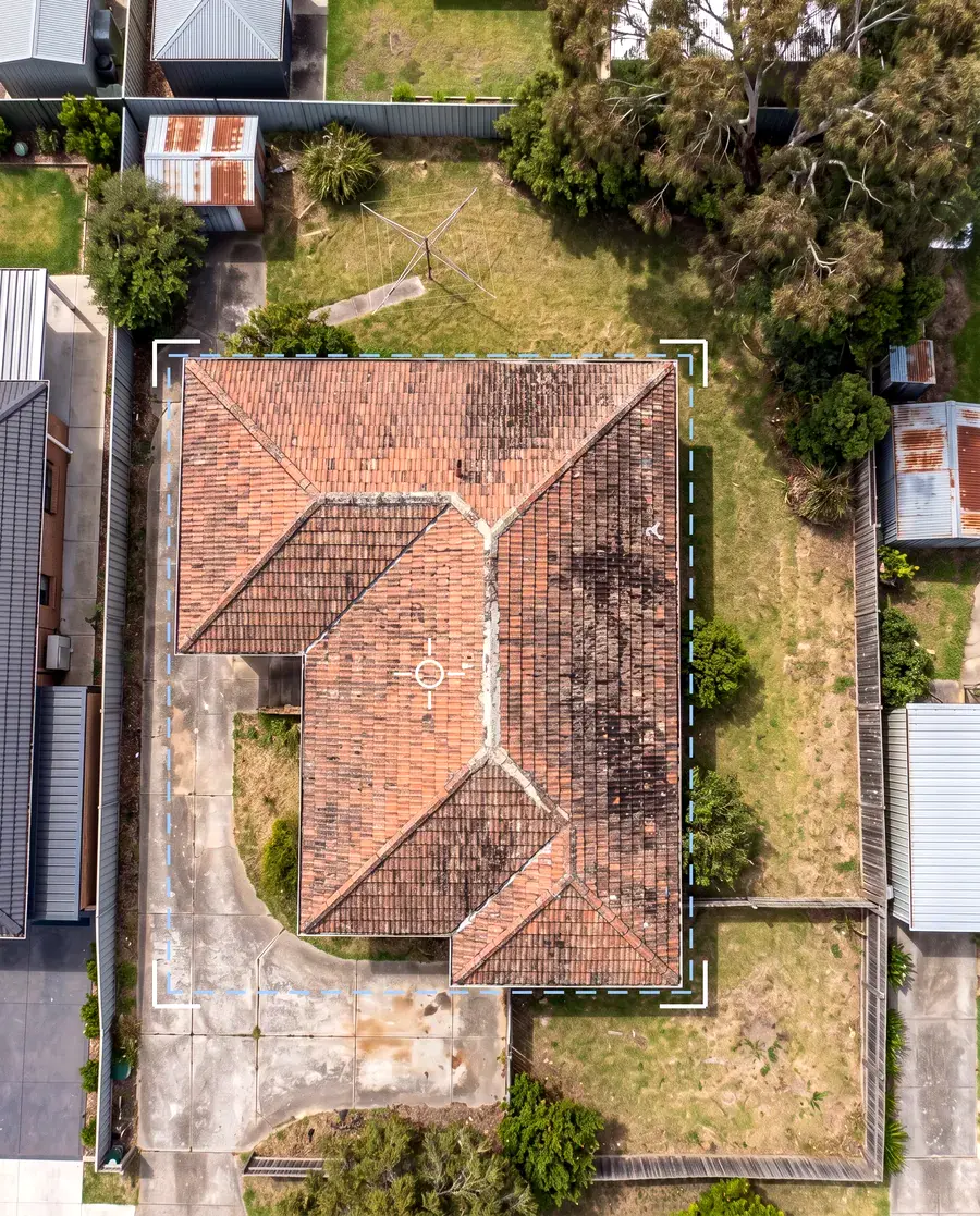 Overhead satellite-style view of a tiled roof with a measuring outline